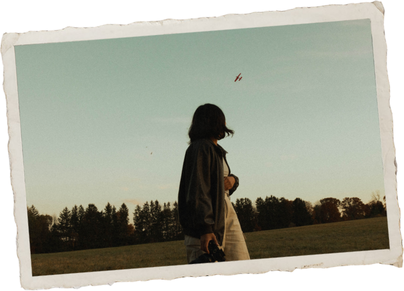 Adventurous portrait of a New York Wedding Photographer in a field at golden hour