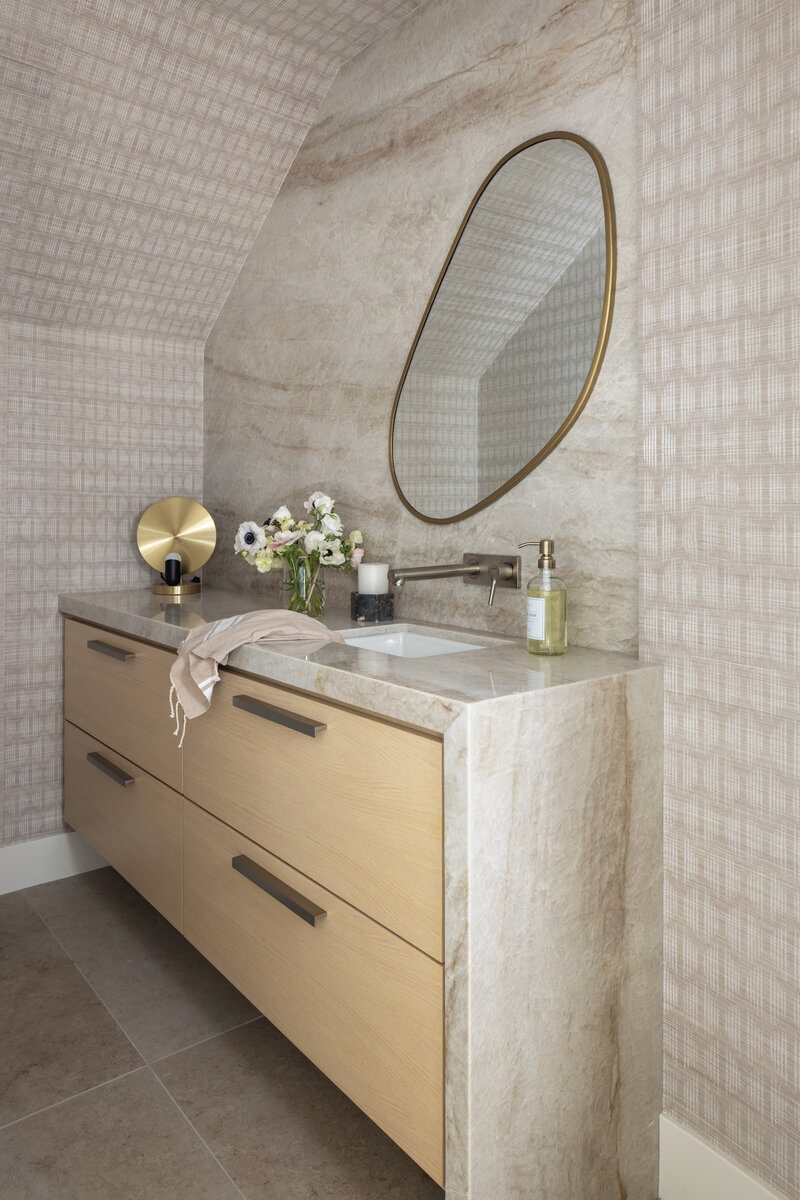 powder bath remodel with white oak cabinets, quartzite countertops,  mirror and wallpaper
