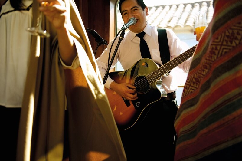 Man singing and playing guitar at a hotel