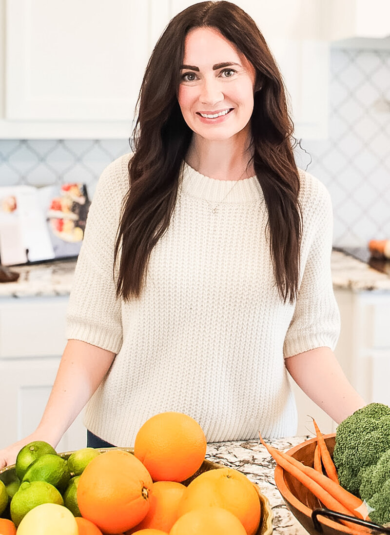 Trish, holistic nutritionist, yoga teacher, and breathwork coach, sitting with water