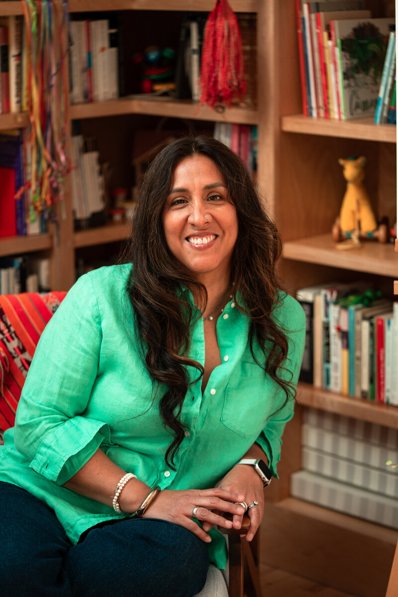 Author photo of Peruvian American children's book author smiling in her studio