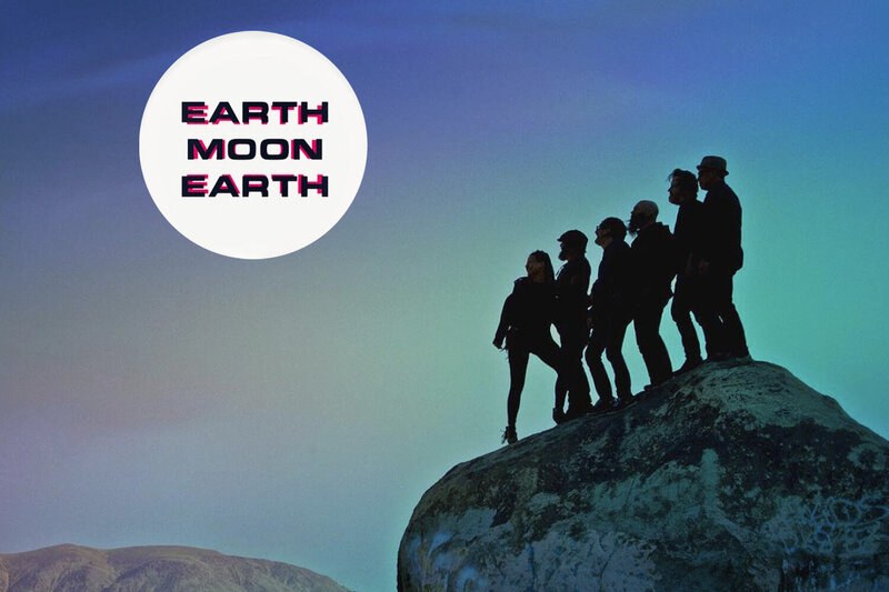 Album cover band Earth Moon Earth standing on large rock in desert looking out at sky