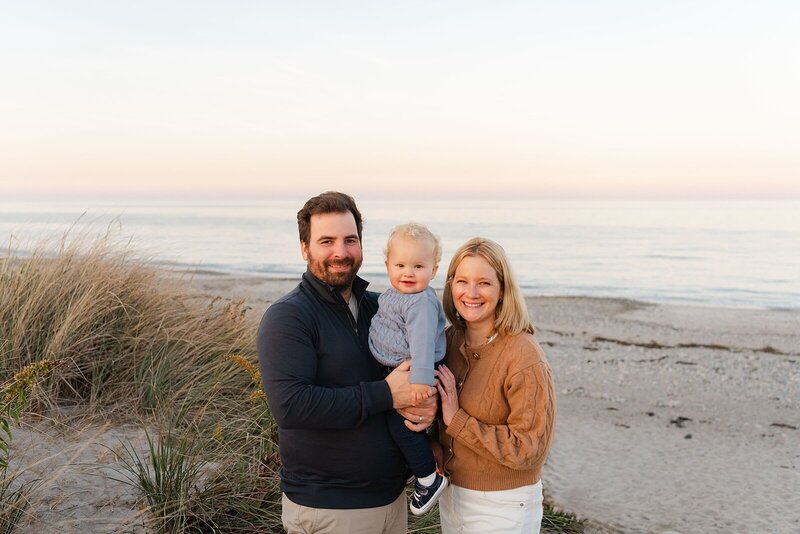 family on beach posing for boston maternity photographer