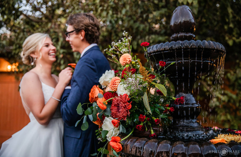 Villa Parker Wedding Photo with fancy fountain decorated with orange flowers in Colorado