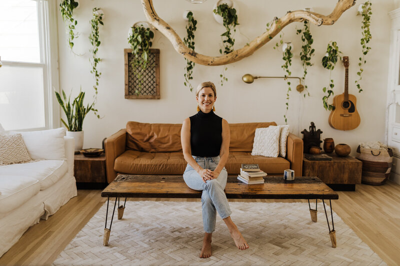 Lela Tuhtan sitting on a coffee table in living room