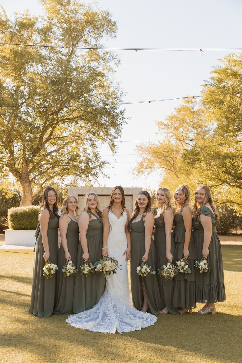 bridesmaids pose for photos at wedding venue in arizona