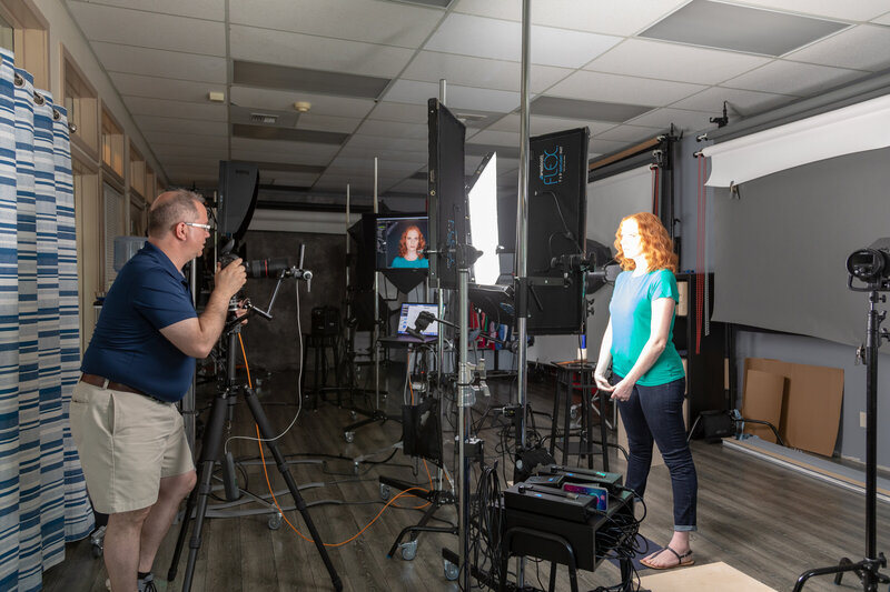 Pete coaching a female for headshot image in studio