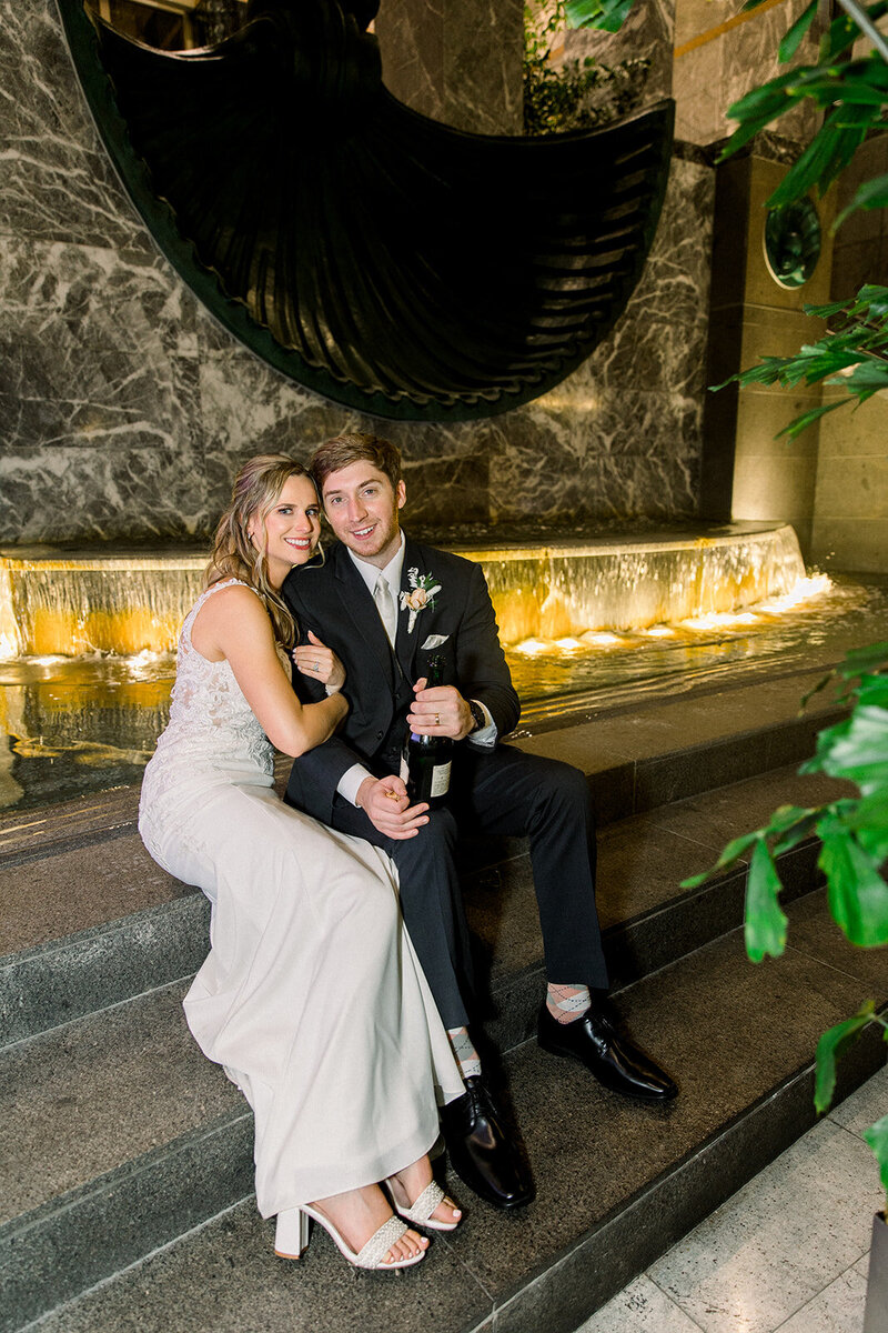 bride and groom portrait by fountain