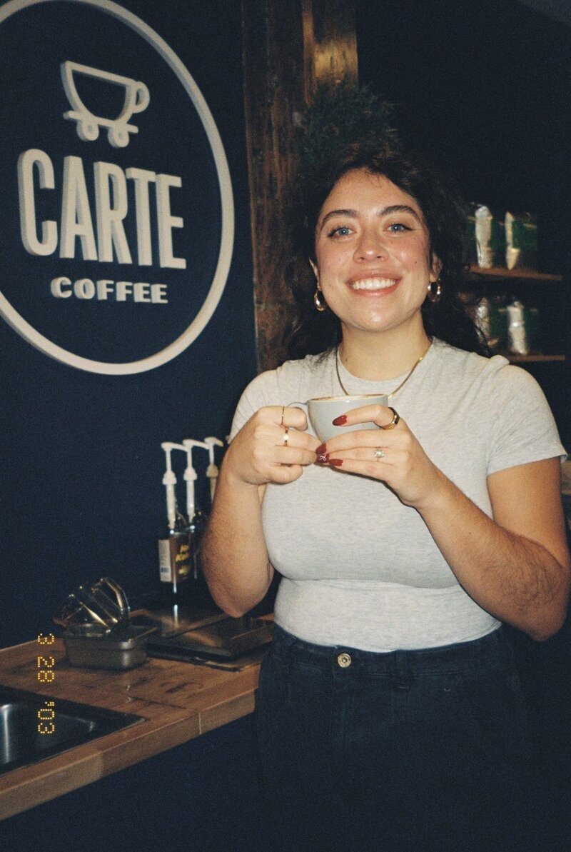 Relaxed branding photo of photographer in Puerto Rico at local coffee shop

