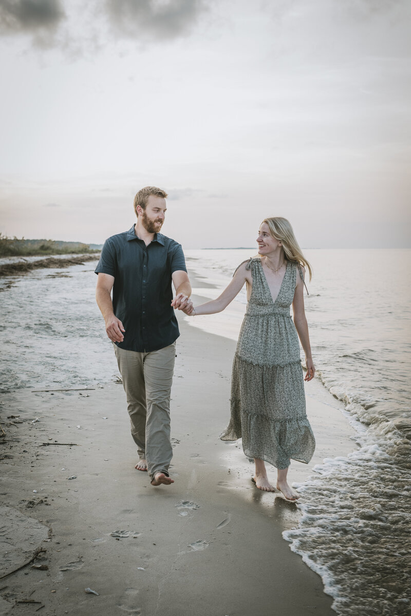 couple walking along the beach at hilton head engagement session