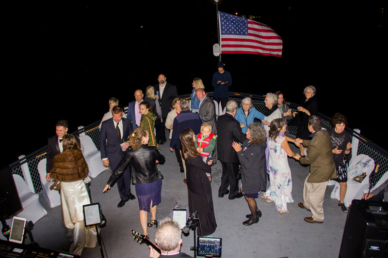 Guests dancing in the dark on boat | Wedding Photography on boat
