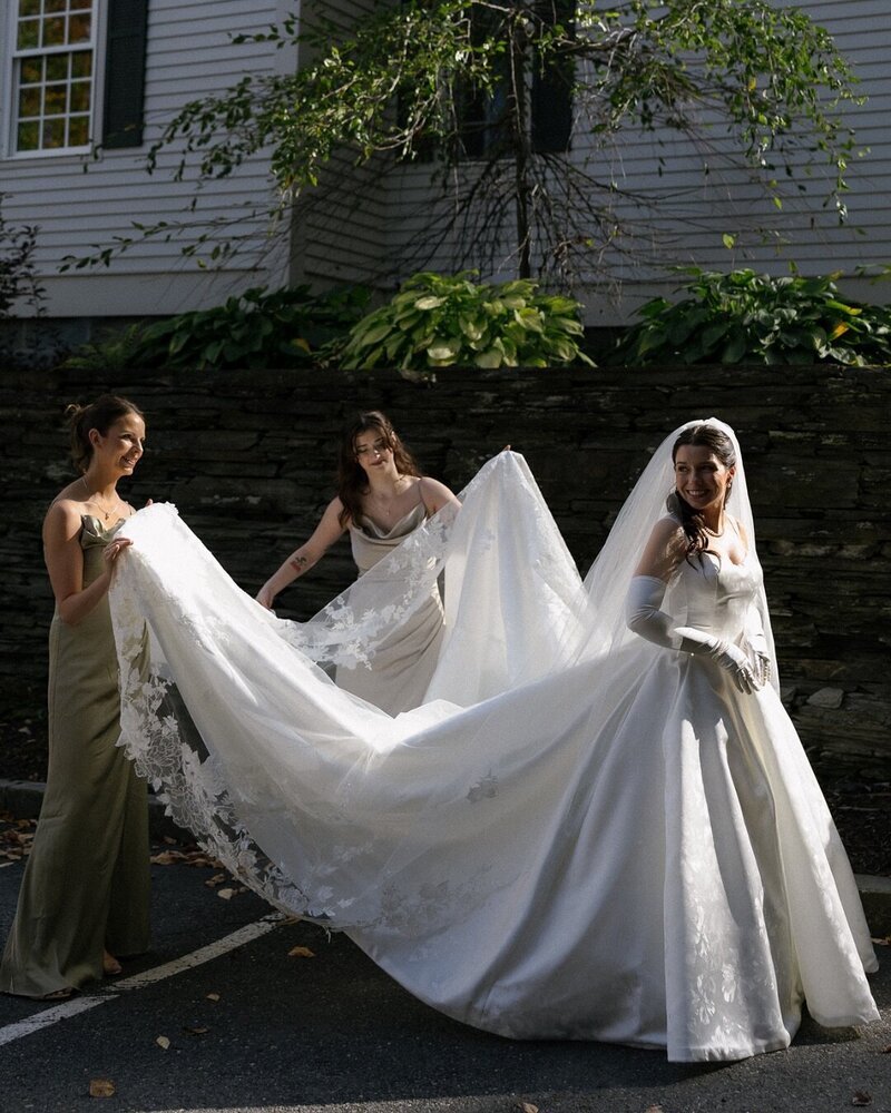 Vermont Wedding Photographer | Sincerely Liz Photography Documentary Wedding, Engagement, Elopement, Maternity and Newborn Photographer in New England | Bridesmaids hold bride's gown and veil as she walks