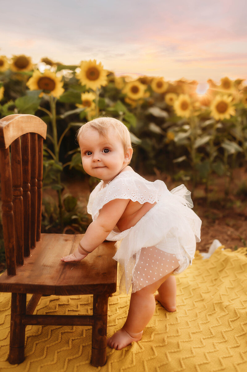 Toddler peers at the camera during Milestone Portrait Session in Charleston, SC.