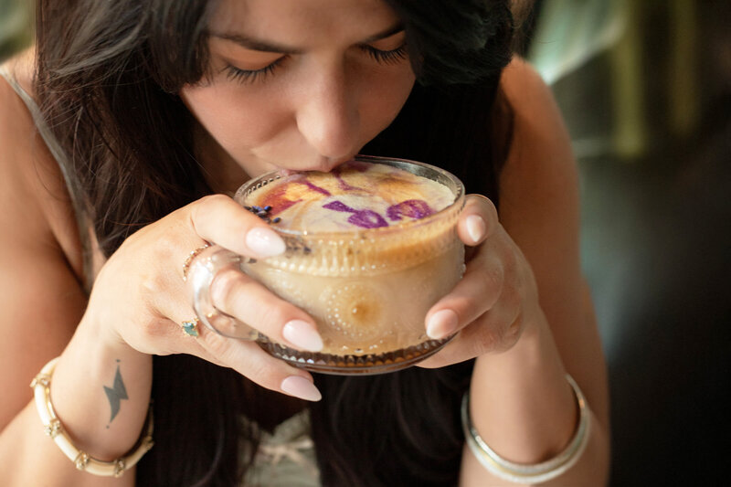 Woman sipping coffee drink in glass cup