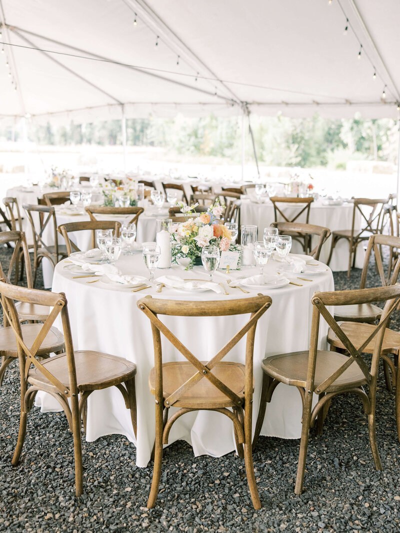 A set table and chairs at a wedding reception, representing Oregon party and event rentals by Birdie June. 