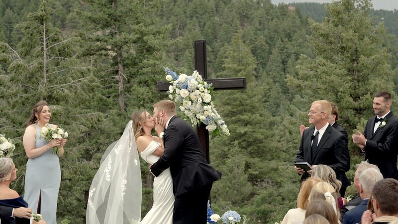 Groom Dipping Bride in Mountain Field