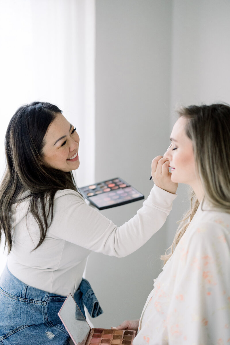 artist applying make-up to client