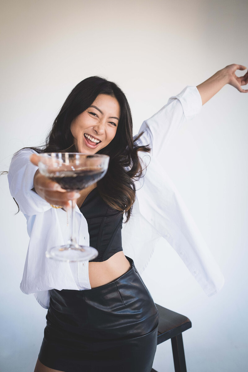 Girl cheerings with martini glass