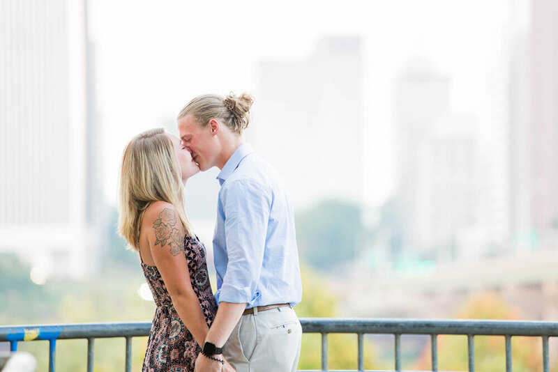 A couple kissing while a Richmond photographer captures their proposal
