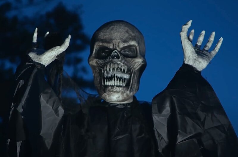 A fake skeleton with it's arms up 