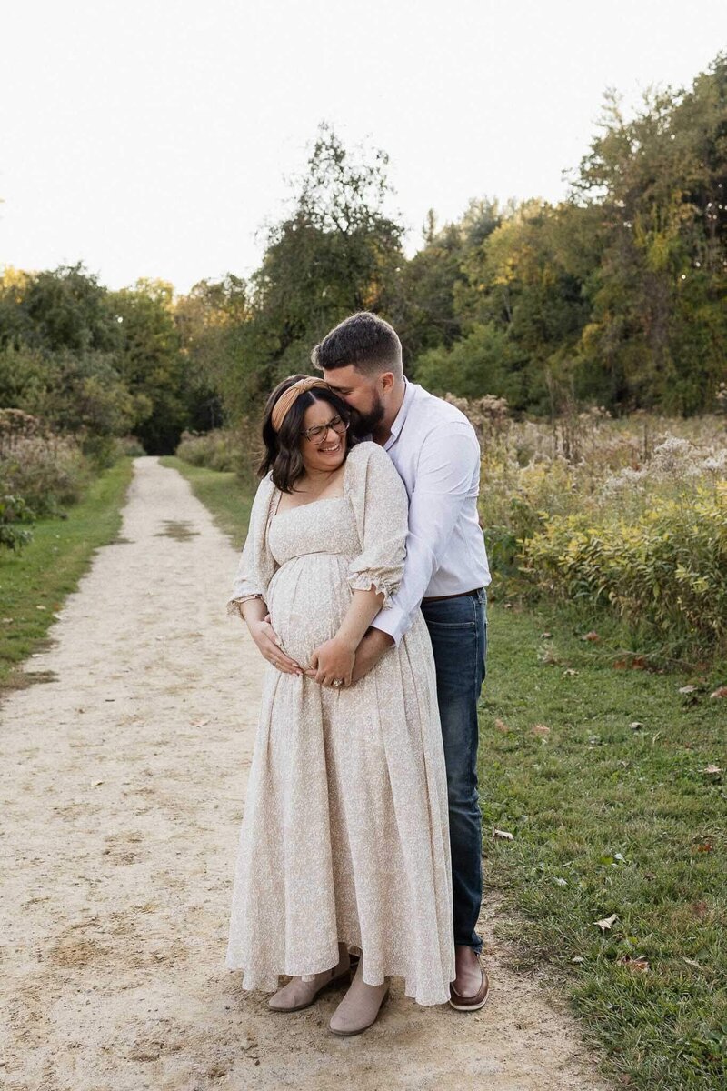 A glowing couple during an outdoor maternity session, showcasing natural, timeless Cleveland family photography.