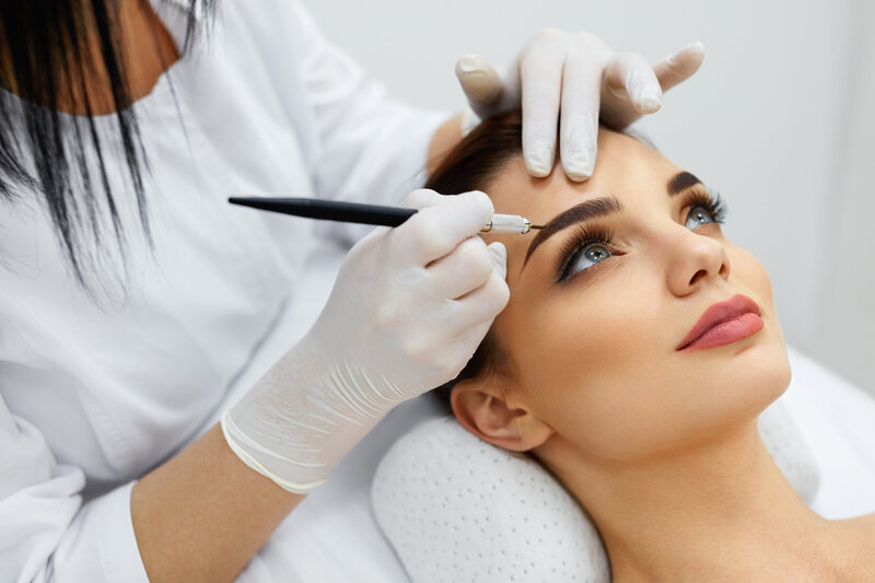 Client receiving an ombre powder brows treatment for a fuller, defined brow look.