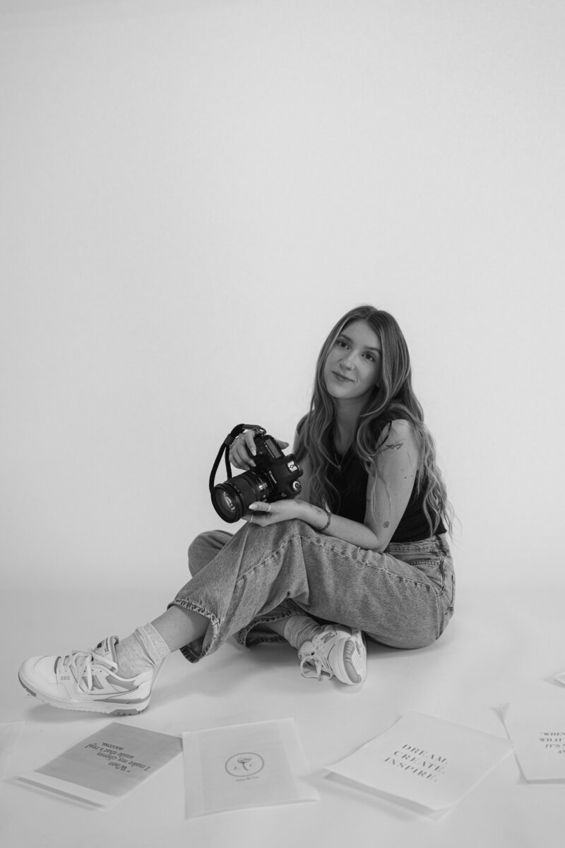 Ontario Photographer Branding picture holding a camera to represent her busines