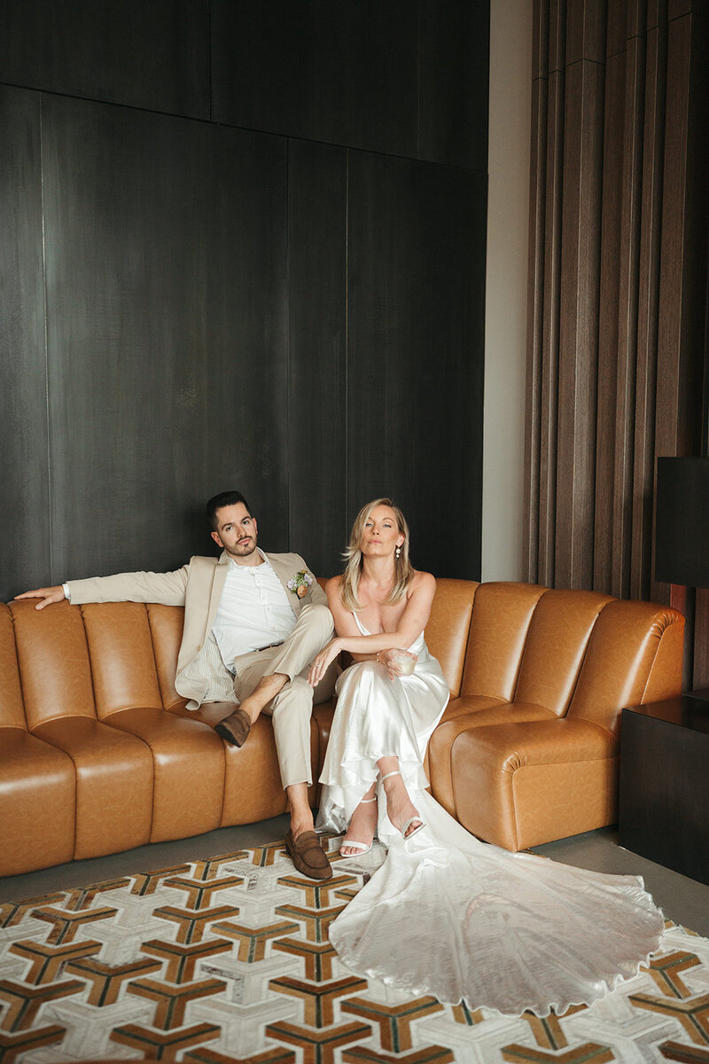 bride and groom sitting on the couch
