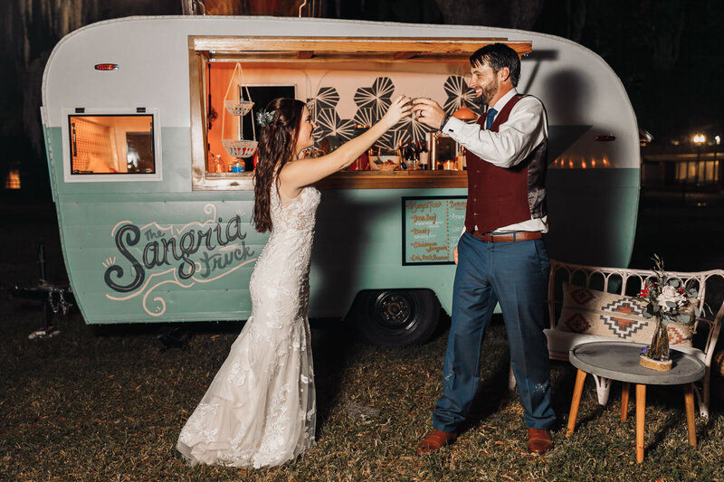 Bride and Groom toast in front of the sangria truck in San Marco wedding venue
