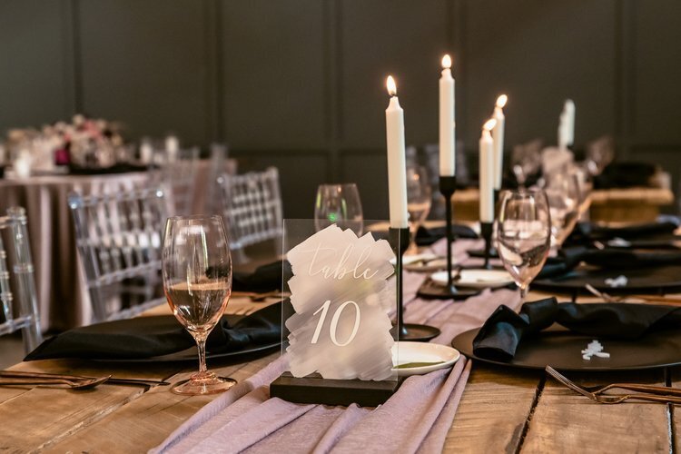 table setting with table number and lit candles