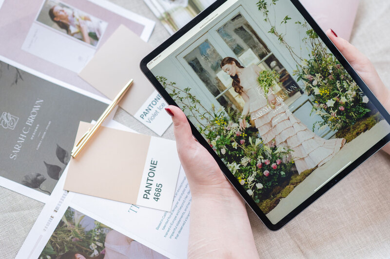 iPad mockup of Sarah C Brown Designs website showing custom brand colour swatches and palette
