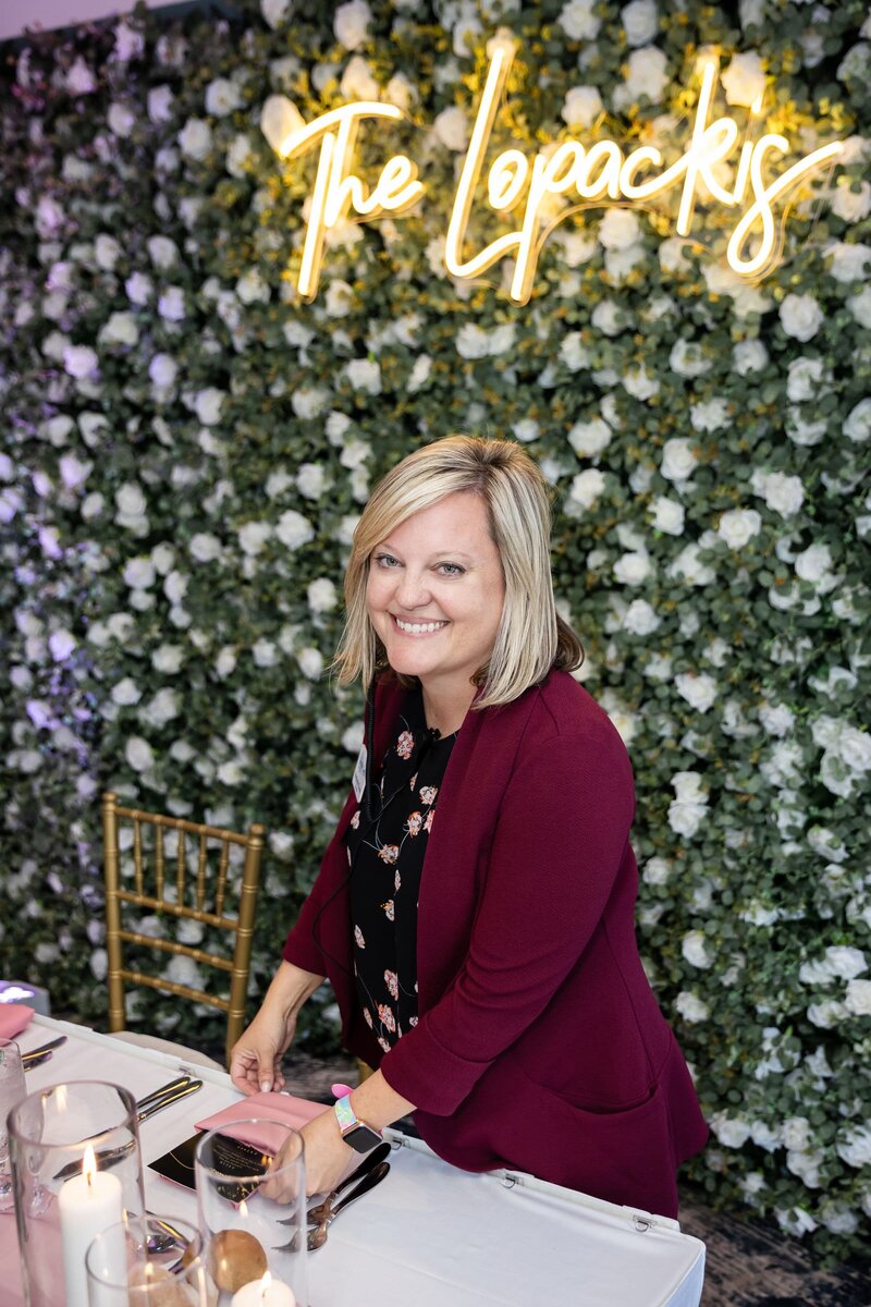 Blonde wedding planner working on a table setting