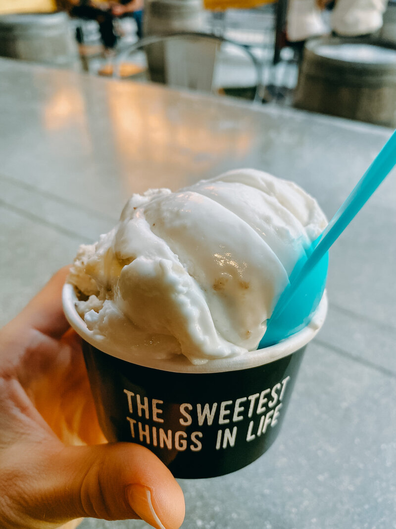 Image of a farmer's market table with fresh vegetables including eggplant, cauliflower, and radishes.