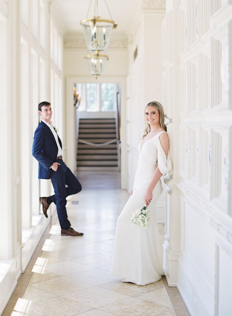Bride and groom share a quiet moment in a grand hallway at a Williamsburg wedding venue, captured by fine art wedding photographer Kaytlyn Rei.