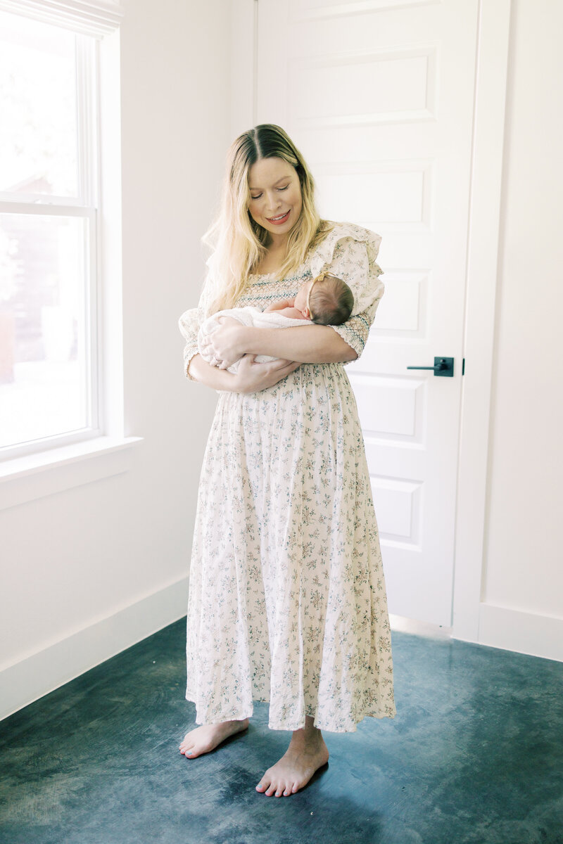 Austin mom cradles her newborn baby.