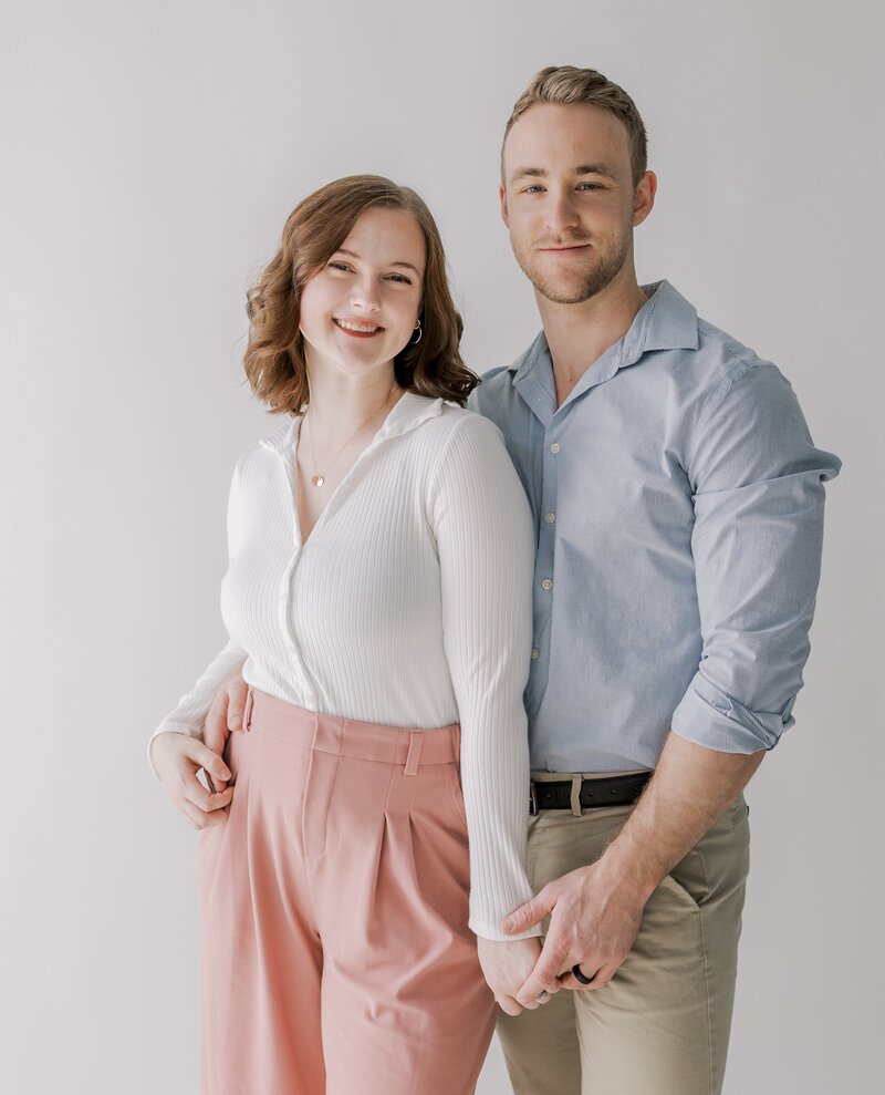 A couple smiles at the camera during their studio session in Richmond VA.