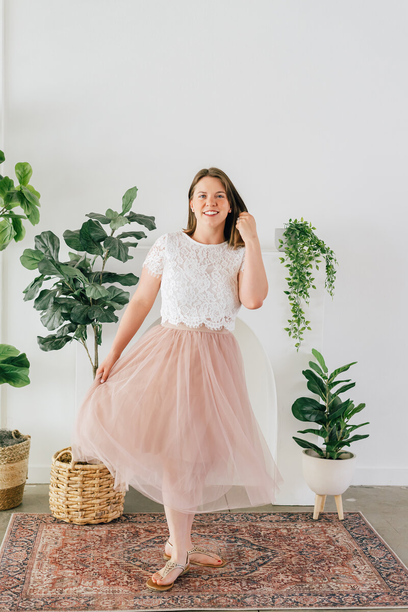 colorado wedding photographers wearing a blush pink tulle skirt with a lace top for her studio headshots in denver