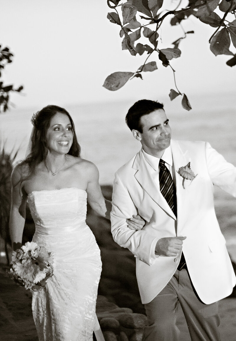 Image of Brian Sellers, a wedding videographer in Williamsburg, VA, and his wife, in love and walking arm in arm on their wedding day