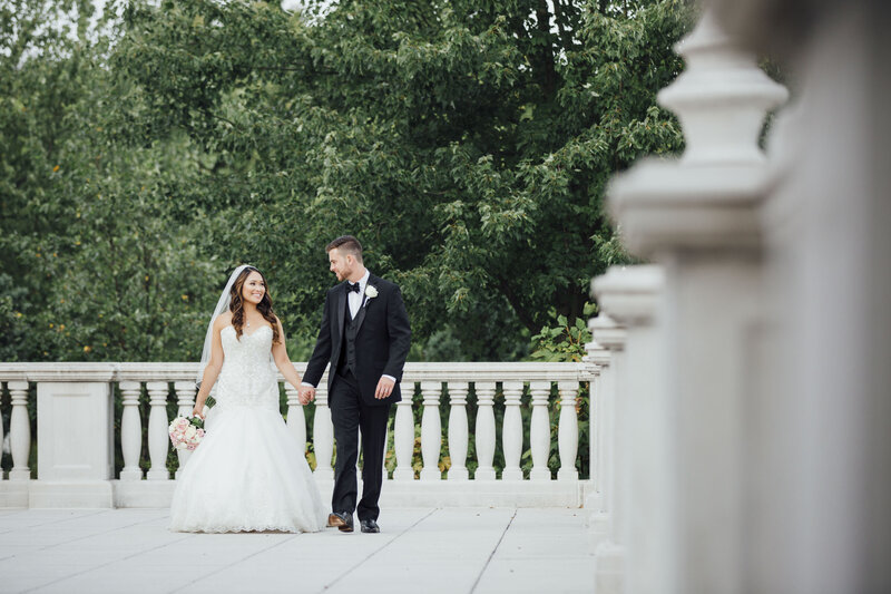 The Palace at Somerset Park Wedding | Couple Holding Hands Walking on Stone Patio | Somerset, New Jersey