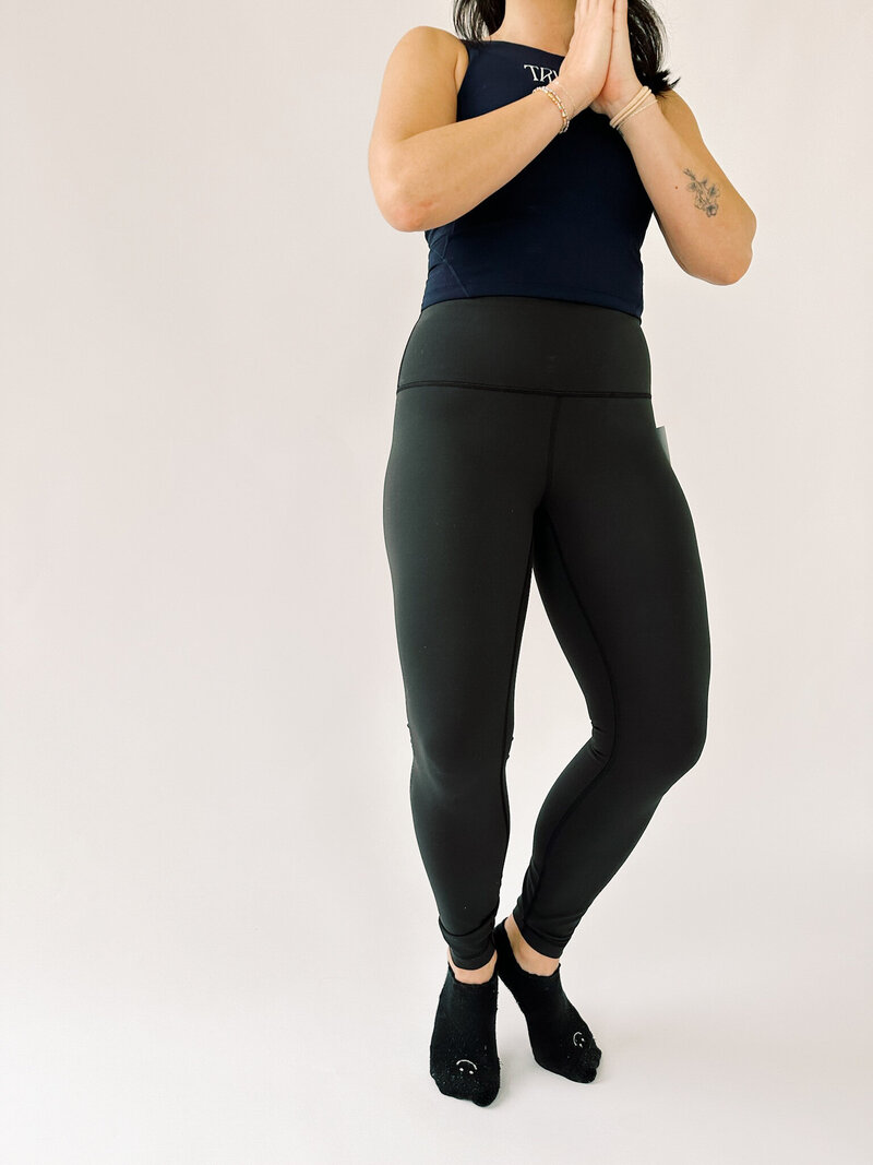 woman wearing navy jogger sweatpants and blue muscle tank
