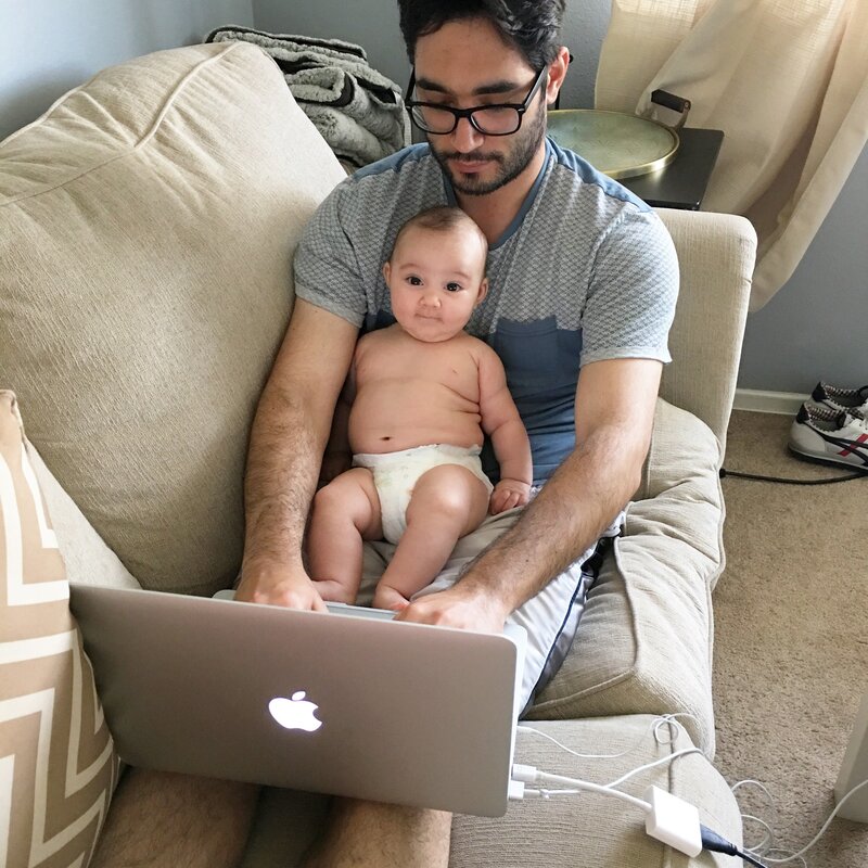 Doug Johnson working from home with his newborn