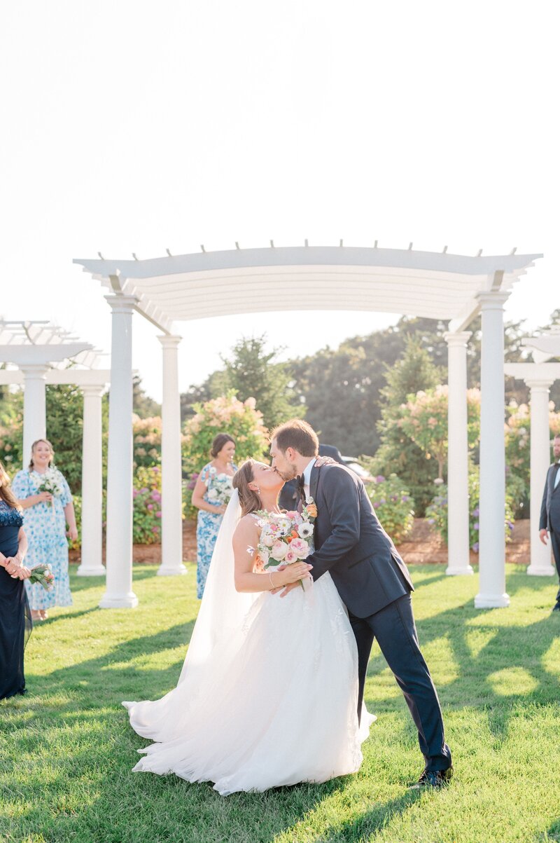 Wedding couple in cape cod kissing