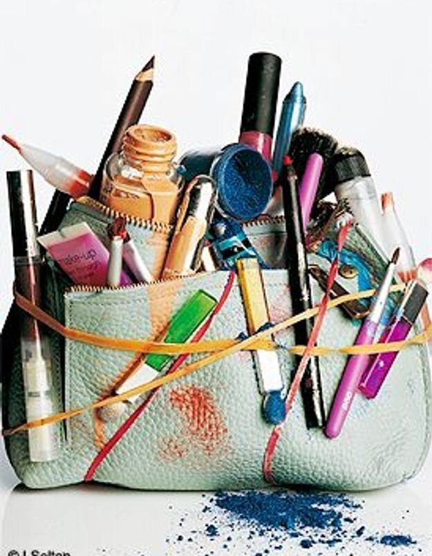 makeup bag stuffed with makeup products foundation lipstick eyeshadow lipgloss
