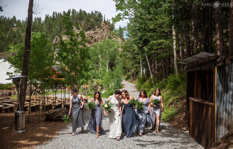 Bride with her friends walk down the path at Blackstone Rivers Ranch