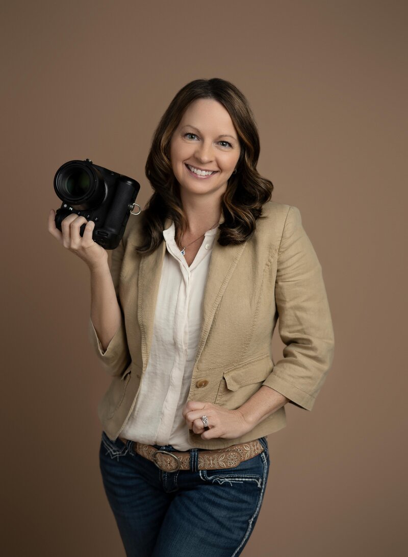 professional headshot of a photographer in a photo studio. Photo taken by Jenni Nikki Photography in Woodstock, GA