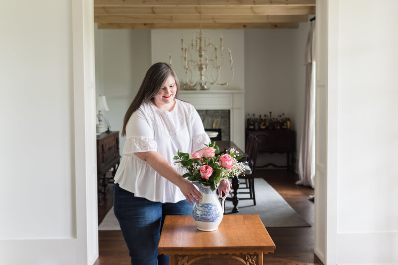 Lauren arranges pink roses in antique vase