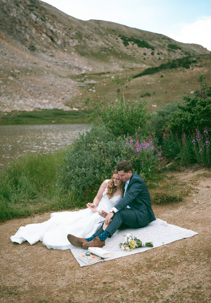 colorado elopement photographer at loveland pass, bride and groom sharing a picnic