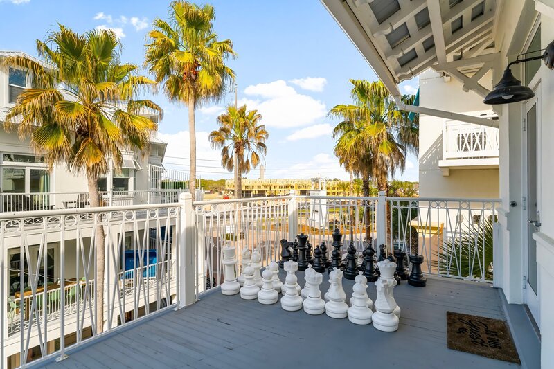 Outdoor giant chess set on private balcony at Carillon Beach vacation rental, perfect for family fun.

