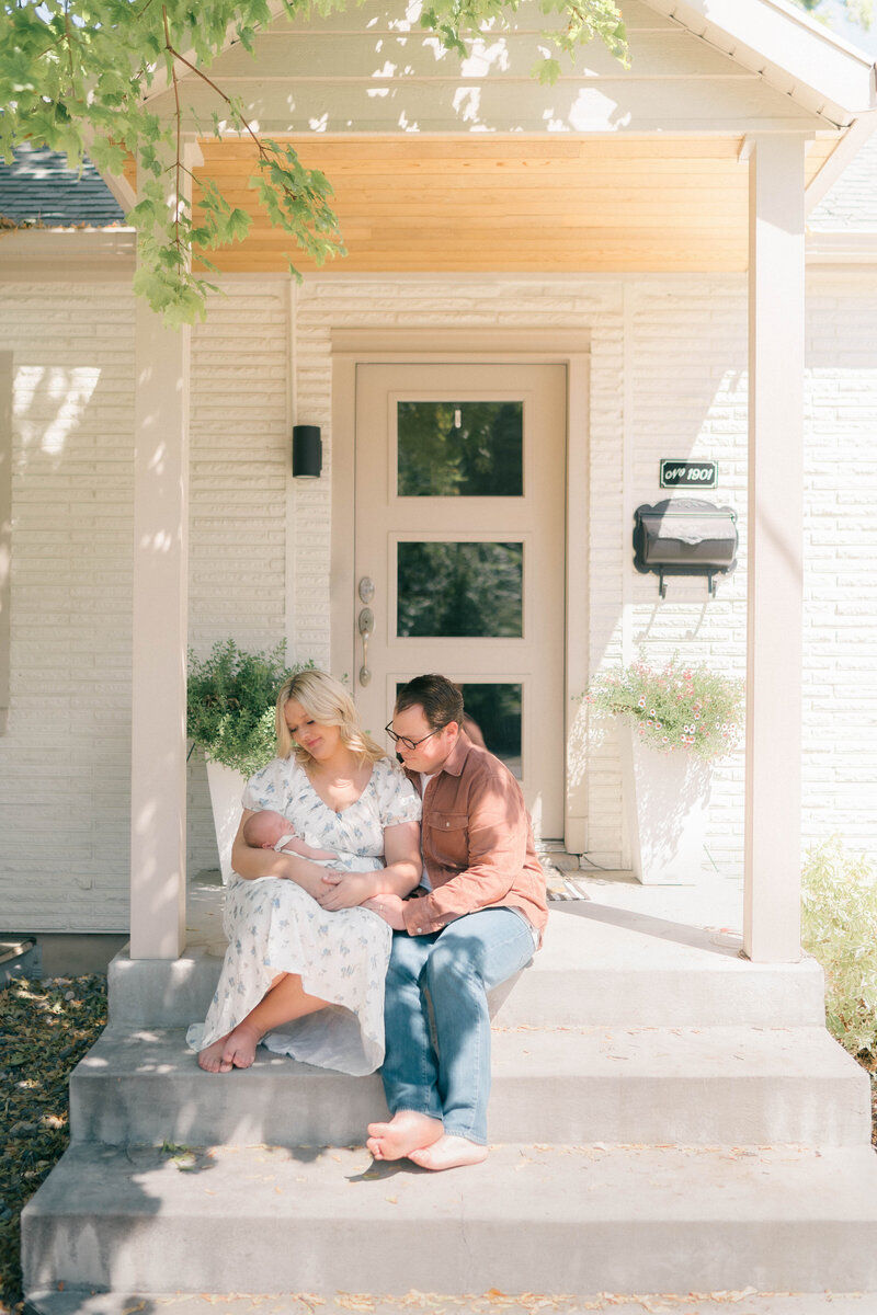 At-home lifestyle newborn session in Salt Lake City by Iris Graciela Photography. Natural light and natural photography capturing soft, delicate moments of connection between baby and family.