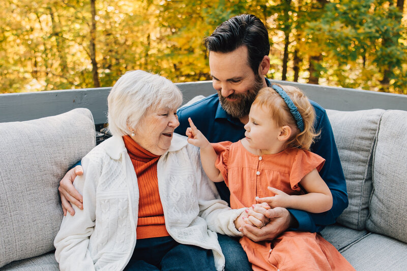 A little girl tapping her grandmother's nose at extended family session